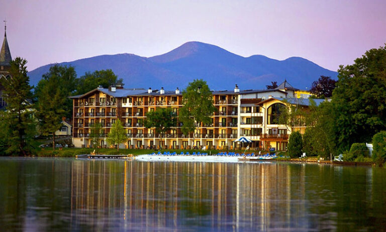 Golde Arrow Resort reaer view from the lake lit at night 768x463