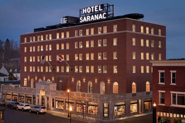 Hotel Saranac exterior lit in evening 768x512