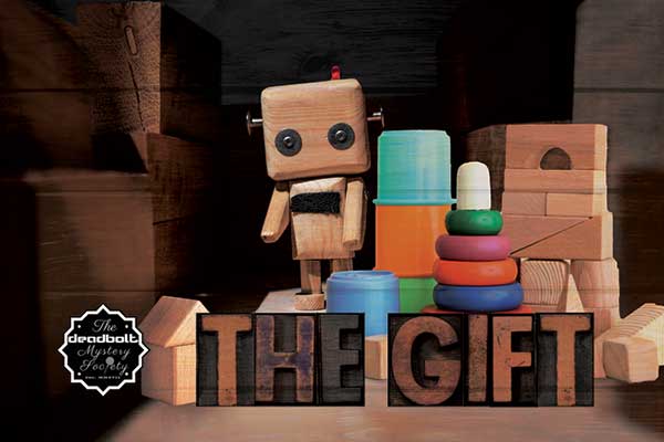 The Gift game cover with child's building blocks and ring toys